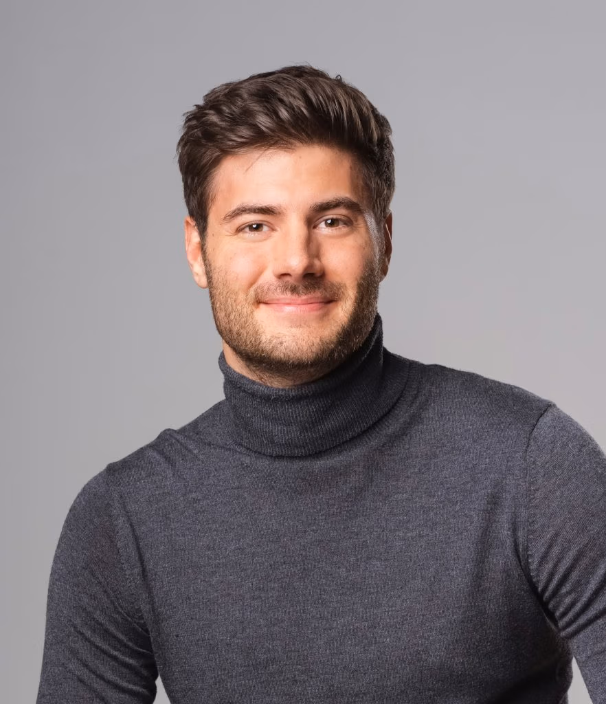 Homme souriant en col roulé gris