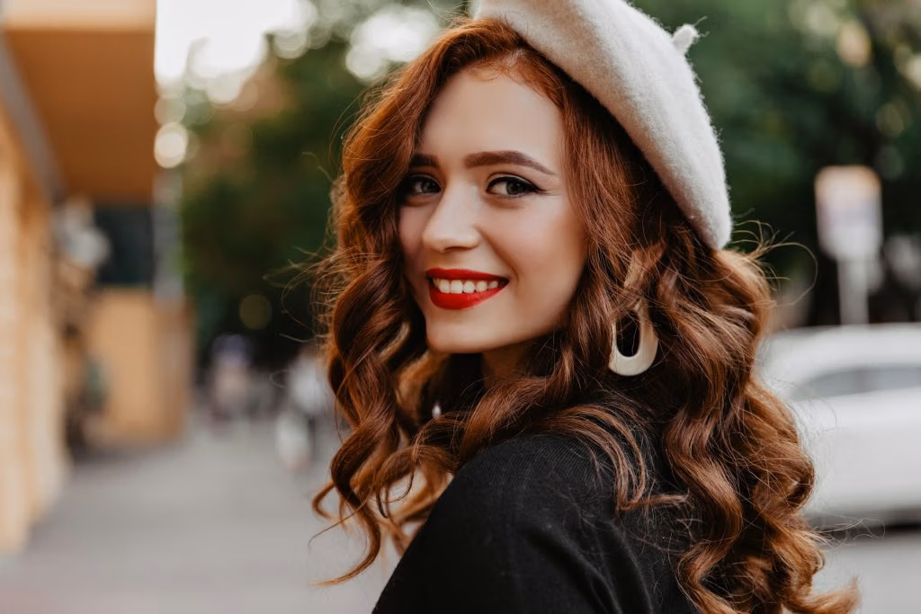 Femme rousse souriante en béret